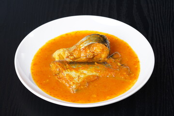 Ikan Patin Masak Tempoyak in a white plate, Ikan Patin Tempoyak is a famous Sumatera heritage dish and it taste spicy.