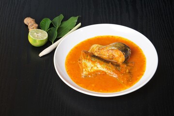 Ikan Patin Masak Tempoyak in a white plate, Ikan Patin Tempoyak is a famous Sumatera heritage dish and it taste spicy.