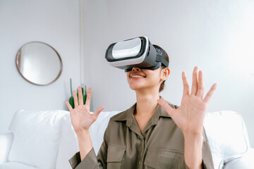 Young woman using virtual reality VR goggle at home for uttermost online shopping experience. The virtual reality VR innovation optimized for digital entertainment lifestyle. - obrazy, fototapety, plakaty
