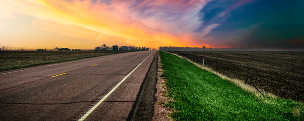 South Dakota Stormy Sunset on the rural road and the agricultural field in Lincoln County, a beautiful landscape of the American Heartland of the Upper Midwest, USA - obrazy, fototapety, plakaty