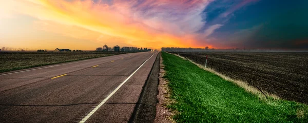 Selbstklebende Fototapeten Cappuccino South Dakota Stormy Sunset on the rural road and the agricultural field in Lincoln County, a beautiful landscape of the American Heartland of the Upper Midwest, USA  © Naya Na