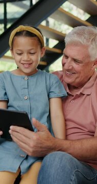 Tablet, search and grandfather with girl child in a house with google it, sign up or movie streaming app. Digital, love and senior man with kid in a living room for Netflix and chill, app or cartoon