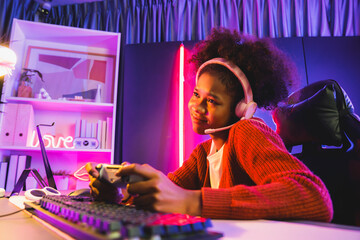 African American girl streamer playing online fighting with Esport skilled team wearing headphones...