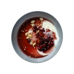 A top view of a bowl filled with yogurt, topped with fresh red berries and crunchy peanuts