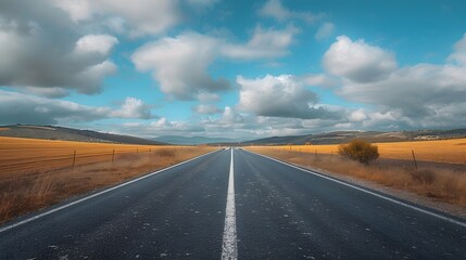 An empty road leading into the distance, with clouds in the sky and fields on both sides. Creating a sense of calmness and focus.