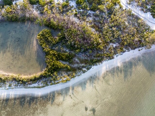 Overhead view of Bonita Beach and a lagoon before the ocean i