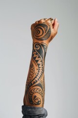 Hand holding up with Maori tattoo person human wrist.