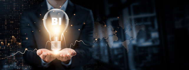 BI: Business Intelligence, Innovation, Insight Concept. Hands of businessman holding light bulb and...