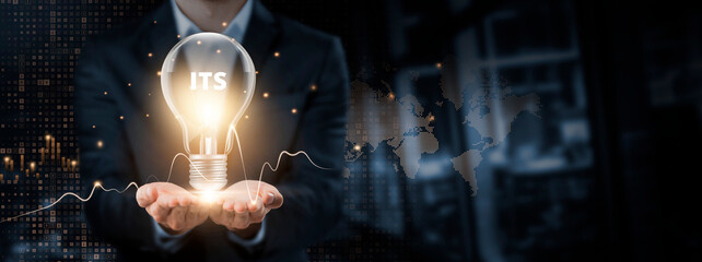 ITS: Innovation, Technology, Sustainability Concept. Hands of businessman holding light bulb and...