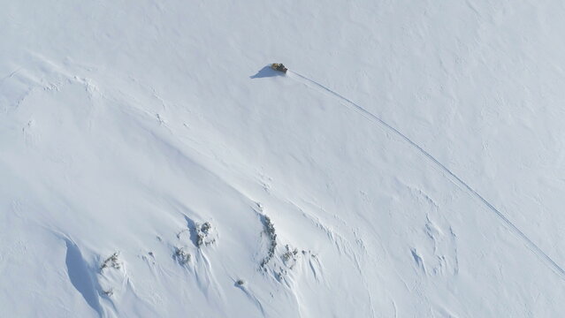 Vintage Snowmobile Ride Snow Surface. Aerial Tracking. Ski-doo Travel Expedition to Antarctica Ice Covered Land. Polar Extreme Activity Top Down Drone View