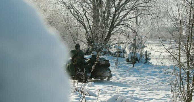 4K Re-enactors Dressed As World War II German Wehrmacht Infantry Soldiers Driving Old Tricar, Three-wheeled Motorcycle in Winter Snowy Forest.