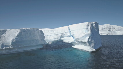 Overview Of Iceberg Among Antarctica Ocean. Aerial view Drone Flight Over Huge Ice Mountain. Sunlit...