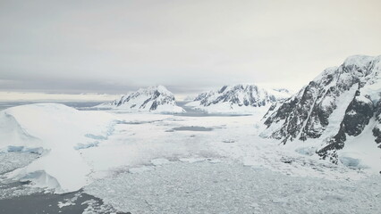 Aerial Flight Over Antarctica Mountains And Ocean. Polar Landscape. Amazing Drone Overview Of Snow,...