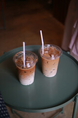 Closeup of Iced Caramel Macchiato at the coffee shop, Caramel Macchiato is a classic macchiato beverage. It consists of vanilla syrup, espresso, steamed milk, foam, and caramel drizzle