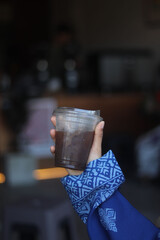 Closeup of Iced Caramel Macchiato at the coffee shop, Caramel Macchiato is a classic macchiato beverage. It consists of vanilla syrup, espresso, steamed milk, foam, and caramel drizzle