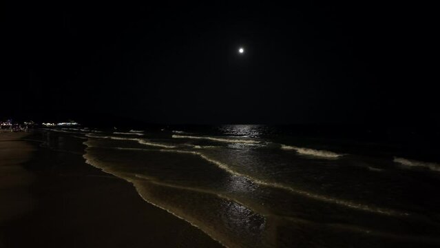 Slow motion 4K litte wave on the beach at night.