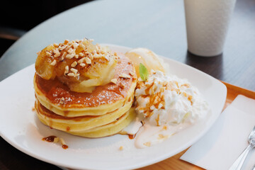 Pancakes with apple, honey, fresh cream, and ice cream.