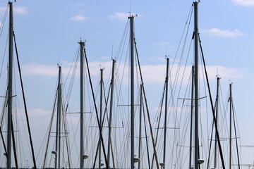Masts in the port against the blue sky.