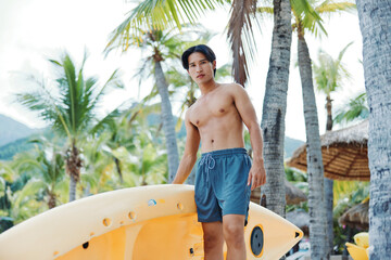 Sunlit Summer Fun: Active Asian Man Canoeing on a Tropical Beach