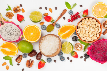 Assorted fresh fruits and nuts on a white background. Ingredients for a healthy dish