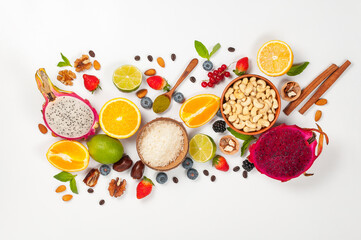 Assorted fresh fruits and nuts on a white background. Ingredients for a healthy dish