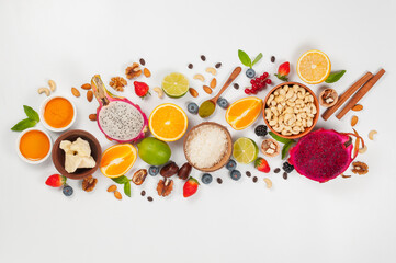 Assorted fresh fruits and nuts on a white background. Ingredients for a healthy dish