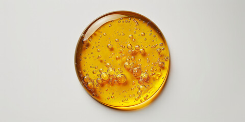 golden yellow round drop of oil with molecules on white background, Golden yellow abstract oil drops