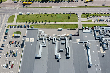 aerial view of shingle roof of shopping mall with ventilation systems. parking lot near supermarket. - 797385772