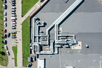 shingle roof of shopping mall with industrial air system of ventilation and air conditioning. aerial photo, top view.