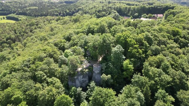 Orbit flight around ruins of Leienfels Castle and tree panorama near Pottenstein (Franconian Switzerland), Germany