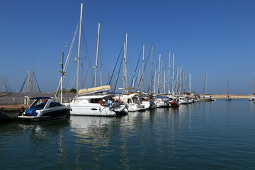 Fototapeta na wymiar Masts in the port against the blue sky.