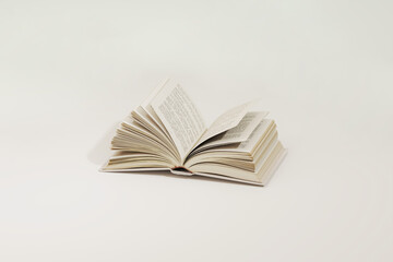 Vintage books stack and podium. Bookcase with old books in the interior. Bookstore, decoration, bookshelves in a beige and white color background. 3D render	
