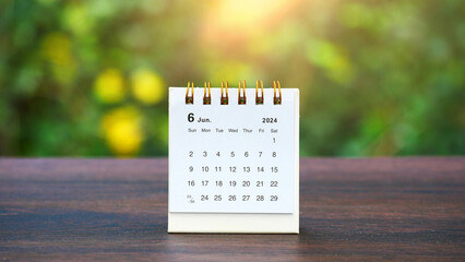 June 2024 month desk calendar on a table with nature background