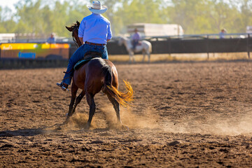 Cowboy competing in a campdraft event at a country rodeo