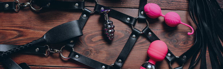 set of BDSM sex toys with handcuffs, whip flogger and vibrator for submission and female...