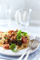Spaghetti Pasta with Vegetables and fresh Basil on bright wooden Background.
