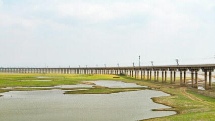 Landscape photograph of a railway track that is a floating bridge in the dry season.