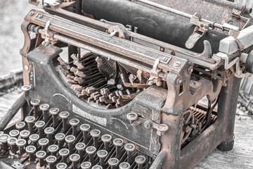 Antique typewriter rusting away in the desert.