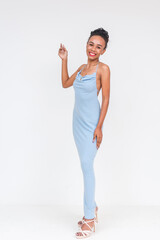 A stylish young woman of mixed African and Asian descent saying hi while in a fashionable powder blue dress, isolated on white.