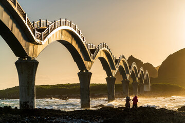 Sunrise view of the beautiful eight cross-Sea arch bridge across the Pacific Ocean coast at...