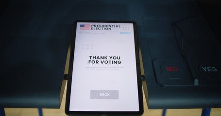Thank you for voting inscription displayed on tablet screen. Voting booth with tablet computer and buttons. Modern digital voting technology. Presidential Elections in the United States of America.