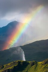 A geyser erupting under a rainbow, steam rising against a backdrop of mountains