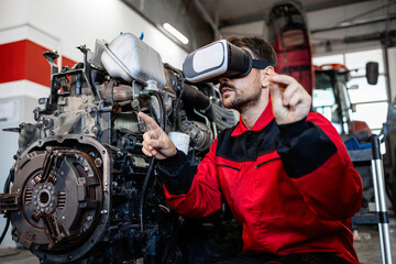 Mechanic using virtual reality glasses and AI technologies while repairing vehicle engine in...