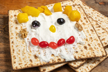 Matzah toast made with creamy cheese, jelly candies, walnuts, mango pieces for Jewish holiday...