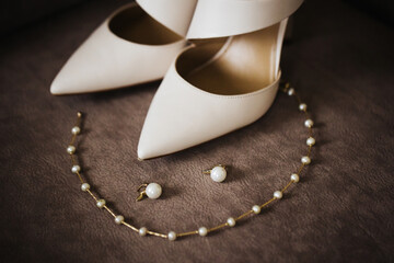 Wedding accesories background. Pearl earrings and necklace. Bride getting ready for the ceremony....