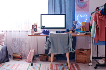No people shot of computer with blank screen on table in modern teenagers room interior, copy space