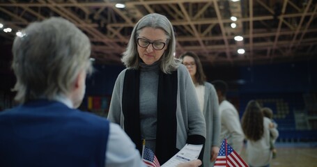 Female American citizen comes to vote in polling station. Political races of US presidential candidates. National Election Day. - obrazy, fototapety, plakaty