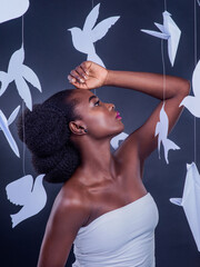 Black woman, paper bird and beauty for freedom, peace and wellness isolated in dark background....