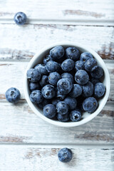 Bilberries on bright wooden background. Concept for healthy nutrition. Close up.	