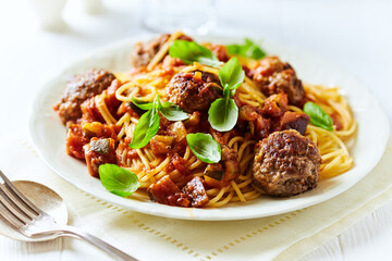 Spaghetti Pasta with Meatballs and fresh Basil o bright background. Close up.
